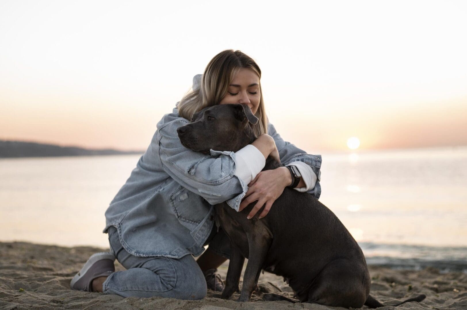 Young woman hugging her pitbull